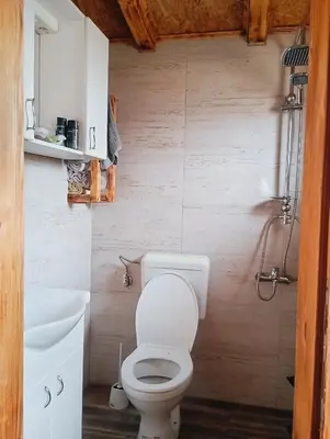 a bathroom with a white toilet and a sink at Kuca za odmor in Vitez