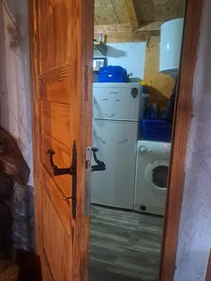 a door open to a kitchen with a washing machine at Kuca za odmor in Vitez