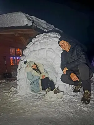 a couple of people sitting in a snow igloo at Kuca za odmor in Vitez