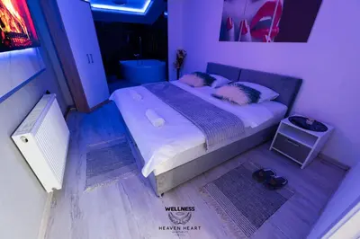 a small bedroom with a bed with two pillows at Heaven Heart - Apartmani Tuzla in Tuzla