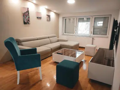 a living room with a couch and a chair at Apartman King centar in Banja Luka