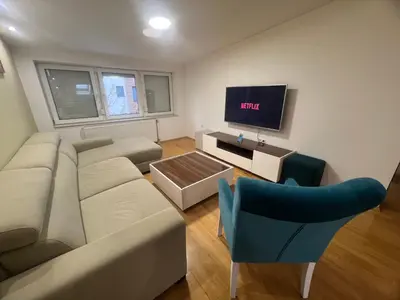 a living room with a couch and a tv at Apartman King centar in Banja Luka