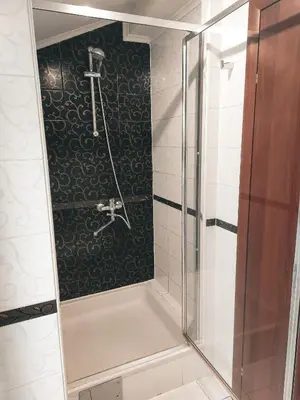 a shower with a glass door in a bathroom at Apartman King centar in Banja Luka