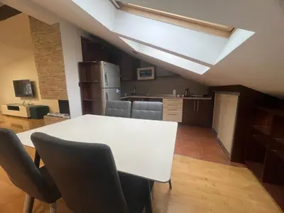 a kitchen with a white table and chairs in a room at Apartman King centar in Banja Luka