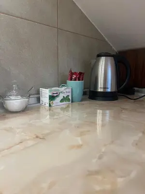 a counter with a tea kettle and a box on it at Apartman King centar in Banja Luka