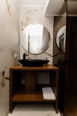 a bathroom with a sink and a mirror at Apartmani VIZIJA in Visoko