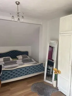 a bedroom with a large bed and a mirror at Studio apartman VB in Banja Luka