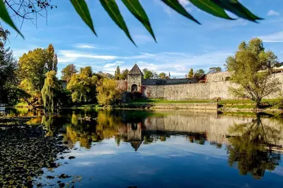 an old castle with a lake in front of it at Studio apartman VB in Banja Luka