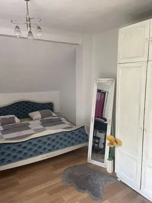 a bedroom with a large bed and a mirror at Studio apartman VB in Banja Luka