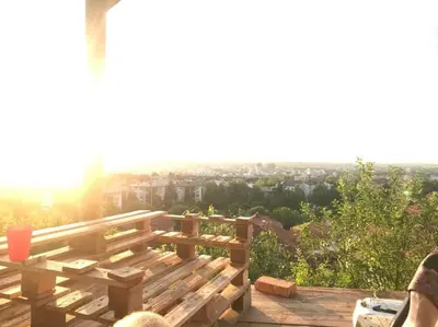 a wooden bench sitting on top of a deck at Studio apartman VB in Banja Luka