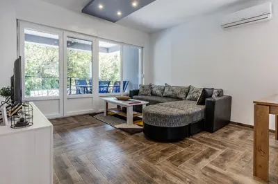 a living room with a couch and a table at Vila Roda in Banja Luka