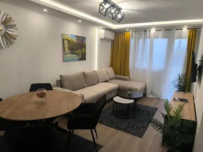 a living room with a couch and a table at Apartman PLAN B in Banja Luka