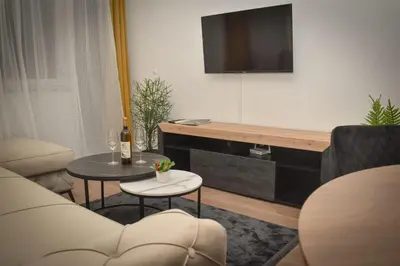 a living room with a couch and a flat screen tv at Apartman PLAN B in Banja Luka