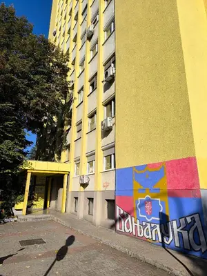 a building with a mural on the side of it at Apartman PLAN B in Banja Luka