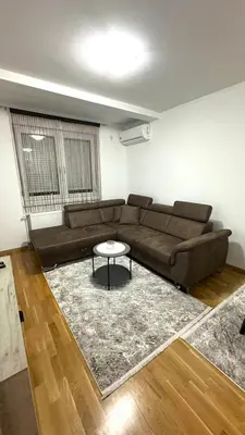 a living room with a couch and a table at Apartman River - stan na dan Gradiška in Bosanska Gradiška