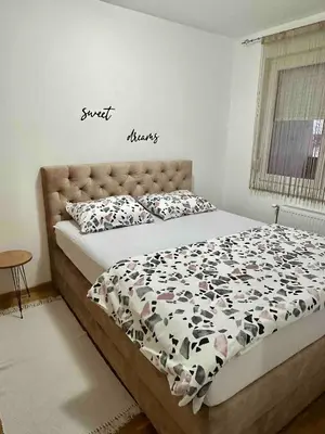 a bedroom with a bed with a cow comforter at Apartman River - stan na dan Gradiška in Bosanska Gradiška
