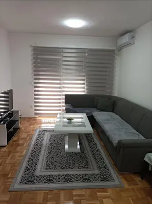 a living room with a couch and a coffee table at VA Apartmani Živinice in Živinice