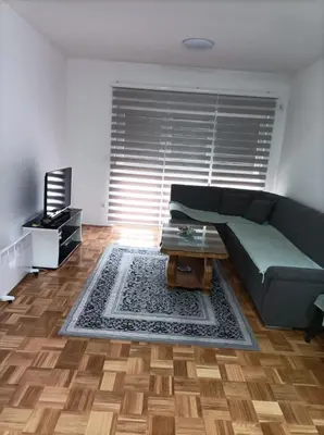 a living room with a couch and a coffee table at VA Apartmani Živinice in Živinice