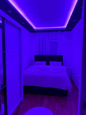 a purple bedroom with a bed with a purple ceiling at Spa stan na dan in Banja Luka