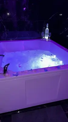 a pink bath tub with a bottle in it at Spa stan na dan in Banja Luka