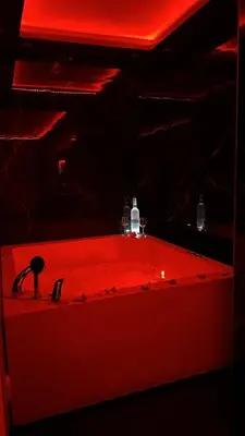 a red sink in a room with a red light at Spa stan na dan in Banja Luka
