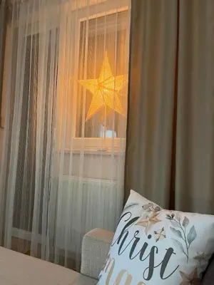 a bedroom with a star hanging from a window at Apartman KIKA in Banja Luka