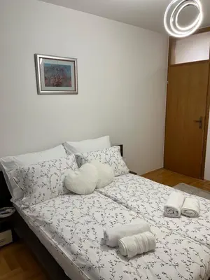 a bedroom with a bed with two towels on it at Apartman KIKA in Banja Luka