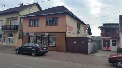 a black car parked in front of a building at Guest house A S S in Sanski most
