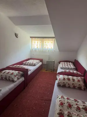 a room with three beds and a window at Sindbad Vlašić in Vlasic