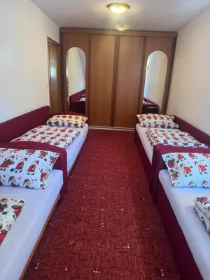 a room with three beds in a room at Sindbad Vlašić in Vlasic