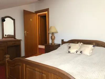a bedroom with a large bed and a mirror at Sindbad Vlašić in Vlasic