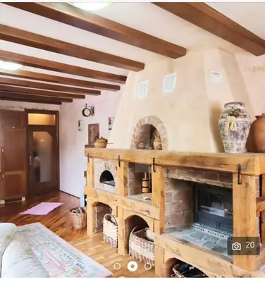 a living room with a large stone fireplace at Sindbad Vlašić in Vlasic