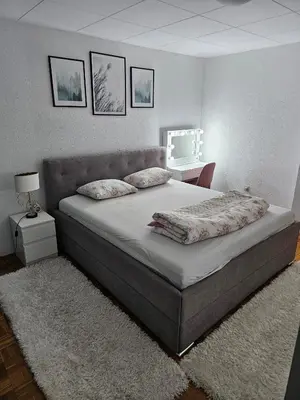 a bedroom with a large bed with two pillows at Apartman Nova Varos in Banja Luka