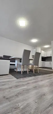 an empty room with a table and two chairs at Apartman Mima in Sanski most