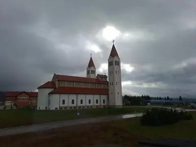 a large building with a clock tower on top of it at Apartman Mika in Kupres