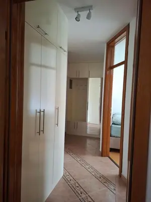 a room with a white cabinet and a bedroom at Apartman Mika in Kupres