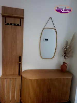 a mirror on a wall next to a wooden cabinet at Perfetto e Splendido! in Banja Luka