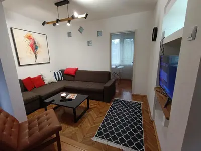 a living room with a couch and a flat screen tv at Apartman Vuk in Drvar