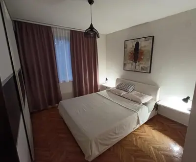 a small bedroom with a bed and a window at Apartman Vuk in Drvar