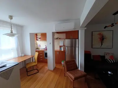 a kitchen and living room with a table and chairs at Apartman Vuk in Drvar