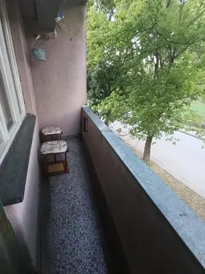 a balcony with two benches next to a window at Apartman Vuk in Drvar
