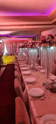 a long table in a room with plates and glasses at Genex-M in Bugojno