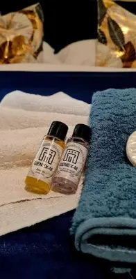 two bottles of essential oils sitting on a pile of towels at Genex-M in Bugojno