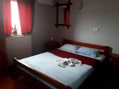 a bedroom with a bed with a ribbon on it at Genex-M in Bugojno