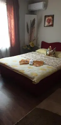 a large bed with a robe on top of it at Genex-M in Bugojno