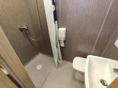 a bathroom with a shower with a toilet and a sink at Ćuranov rep in Mrkonjić Grad