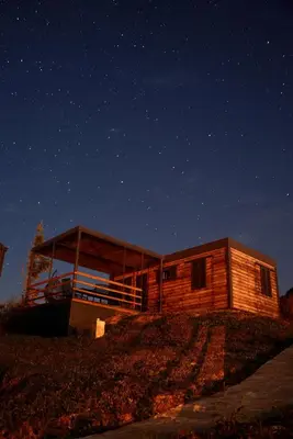 a wooden cabin at night with a starry sky at Ćuranov rep in Mrkonjić Grad