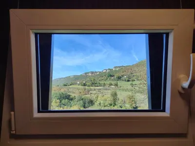 a window with a view of a mountain at Ćuranov rep in Mrkonjić Grad