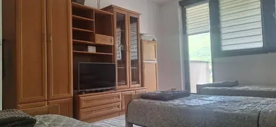 a bedroom with a entertainment center with a tv at Tamara in Drvar