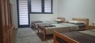 a room with three beds and a window at Tamara in Drvar